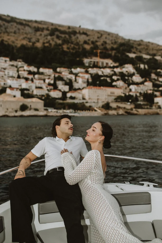 couple photoshoot on small boat with view on dubrovnik
