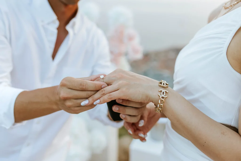 guy putting a ring on a girls finger